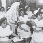 Sister teaching nursing students in class